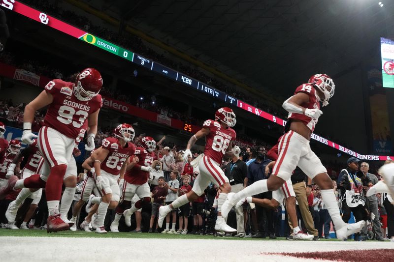 Dec 29, 2021; San Antonio, Texas, USA; Oklahoma Sooners players enter the field before the 2021 Alamo Bowl against the Oregon Ducks at Alamodome. Mandatory Credit: Kirby Lee-USA TODAY Sports