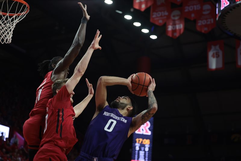 Mar 5, 2023; Piscataway, New Jersey, USA; Northwestern Wildcats guard Boo Buie (0) shoots the ball as Rutgers Scarlet Knights guard Cam Spencer (10) and center Clifford Omoruyi (11) defend during the first half at Jersey Mike's Arena. Mandatory Credit: Vincent Carchietta-USA TODAY Sports