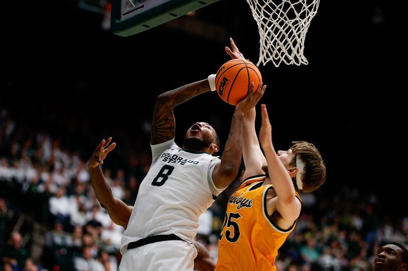 Feb 15, 2025; Fort Collins, Colorado, USA; Colorado State Rams forward Jaylen Crocker-Johnson (8) drives to the net against Wyoming Cowboys forward Touko Tainamo (25) in the second half at Moby Arena. Mandatory Credit: Isaiah J. Downing-Imagn Images