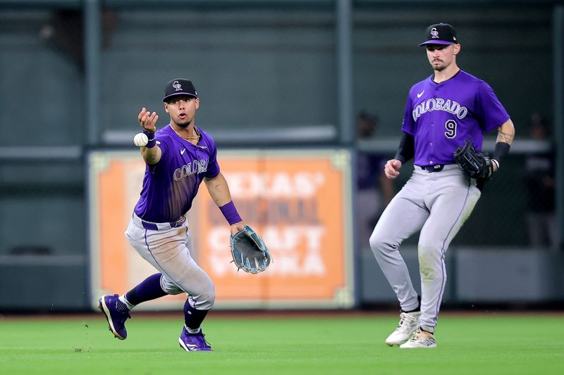 Jun 26, 2024; Houston, Texas, USA; Colorado Rockies shortstop Ezequiel Tovar (14) is unable to catch a fly ball hit by Houston Astros first baseman Jon Singleton (not shown) during the seventh inning at Minute Maid Park. Mandatory Credit: Erik Williams-USA TODAY Sports