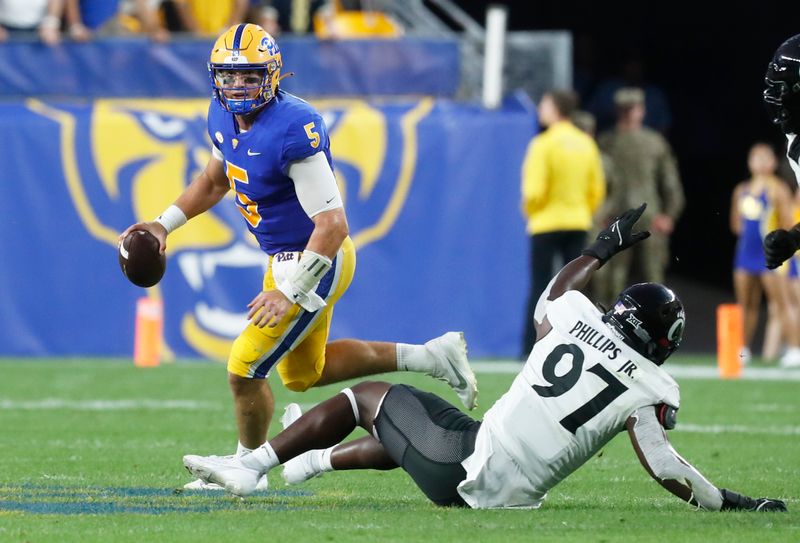 Sep 9, 2023; Pittsburgh, Pennsylvania, USA; Pittsburgh Panthers quarterback Phil Jurkovec (5) scrambles with the ball against the Cincinnati Bearcats during the second quarter at Acrisure Stadium. Mandatory Credit: Charles LeClaire-USA TODAY Sports