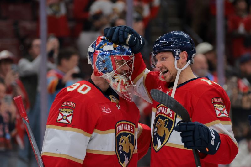 Nov 30, 2024; Sunrise, Florida, USA; Florida Panthers goaltender Spencer Knight (30) celebrates with center Sam Reinhart (13) after the game against the Carolina Hurricanes at Amerant Bank Arena. Mandatory Credit: Sam Navarro-Imagn Images