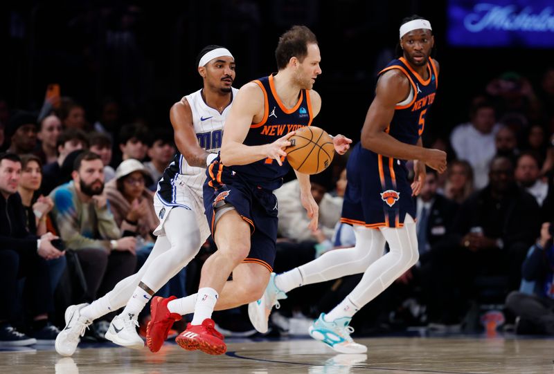 NEW YORK, NEW YORK - MARCH 08: Bojan Bogdanovic #44 of the New York Knicks dribbles as Gary Harris #14 of the Orlando Magic defends during the first half at Madison Square Garden on March 08, 2024 in New York City. NOTE TO USER: User expressly acknowledges and agrees that, by downloading and or using this photograph, User is consenting to the terms and conditions of the Getty Images License Agreement. (Photo by Sarah Stier/Getty Images)