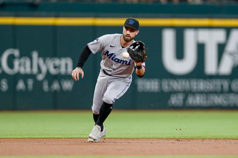 Aug 6, 2023; Arlington, Texas, USA; Miami Marlins shortstop Jon Berti (5) fields a ground ball during the first inning against the Texas Rangers at Globe Life Field. Mandatory Credit: Andrew Dieb-USA TODAY Sports