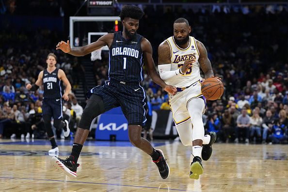 ORLANDO, FLORIDA - NOVEMBER 04: LeBron James #23 of the Los Angeles Lakers drives the ball past Jonathan Isaac #1 of the Orlando Magic during the first half at Amway Center on November 04, 2023 in Orlando, Florida. NOTE TO USER: User expressly acknowledges and agrees that, by downloading and or using this photograph, User is consenting to the terms and conditions of the Getty Images License Agreement. (Photo by Rich Storry/Getty Images)