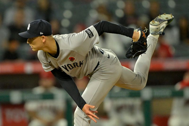 May 26, 2025; Anaheim, California, USA;  New York Yankees relief pitcher Luke Weaver (30) delivers to the plate in the ninth inning against the Los Angeles Angels at Angel Stadium. Mandatory Credit: Jayne Kamin-Oncea-Imagn Images