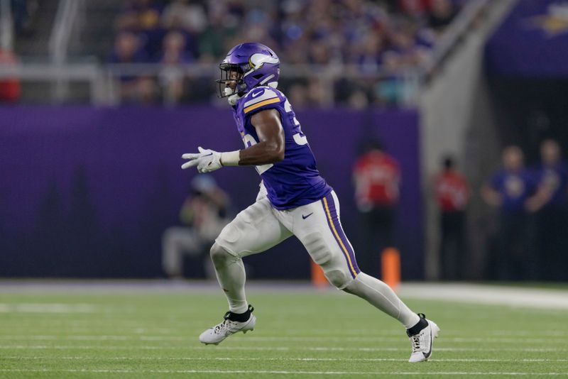 Minnesota Vikings running back Ty Chandler (32) in action during the second half of an NFL preseason football game against the Tennessee Titans, Saturday, Aug. 19, 2023 in Minneapolis. Tennessee won 24-16. (AP Photo/Stacy Bengs)