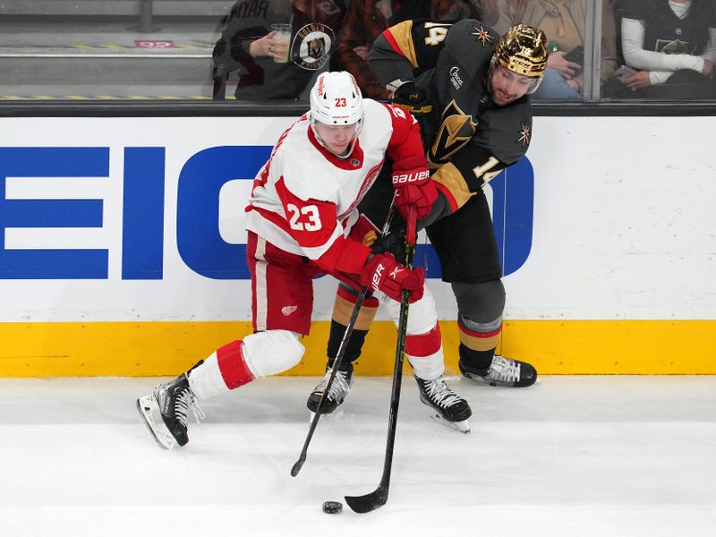 Jan 19, 2023; Las Vegas, Nevada, USA; Detroit Red Wings left wing Lucas Raymond (23) steals the puck from Vegas Golden Knights defenseman Nicolas Hague (14) during the third period at T-Mobile Arena. Mandatory Credit: Stephen R. Sylvanie-USA TODAY Sports