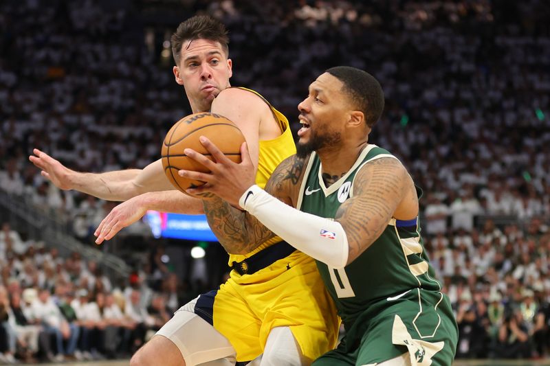 MILWAUKEE, WISCONSIN - APRIL 23: Damian Lillard #0 of the Milwaukee Bucks drives to the basket against T.J. McConnell #9 of the Indiana Pacers during the second half of game two of the Eastern Conference First Round Playoffs at Fiserv Forum on April 23, 2024 in Milwaukee, Wisconsin. NOTE TO USER: User expressly acknowledges and agrees that, by downloading and or using this photograph, User is consenting to the terms and conditions of the Getty Images License Agreement. (Photo by Stacy Revere/Getty Images)