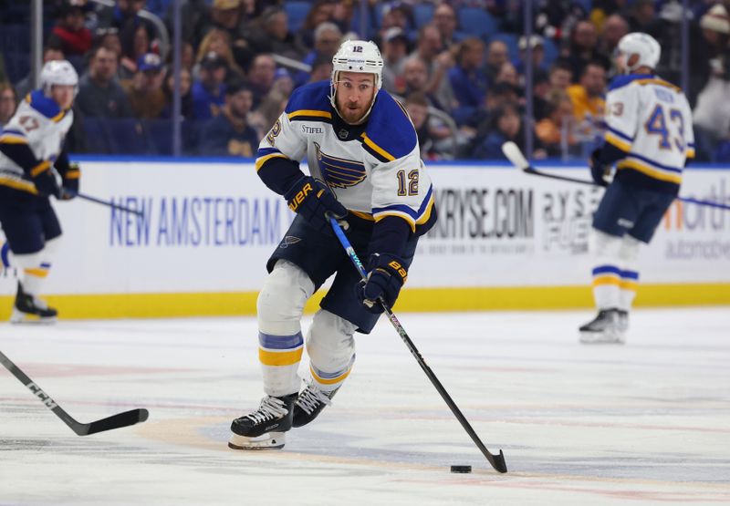 Feb 10, 2024; Buffalo, New York, USA;  St. Louis Blues right wing Kevin Hayes (12) skates up ice with the puck during the first period against the Buffalo Sabres at KeyBank Center. Mandatory Credit: Timothy T. Ludwig-USA TODAY Sports