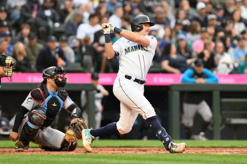 Jun 14, 2023; Seattle, Washington, USA; Seattle Mariners catcher Cal Raleigh (29) hits a double against the Miami Marlins during the fifth inning at T-Mobile Park. Mandatory Credit: Steven Bisig-USA TODAY Sports