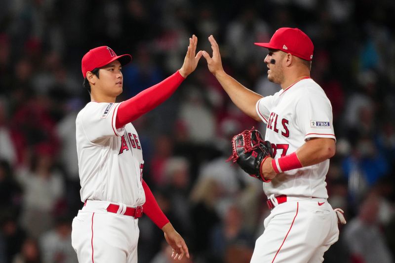 May 24, 2023; Anaheim, California, USA; Los Angeles Angels designated hitter Shohei Ohtani (17) and center fielder Mike Trout (27) celebrate after the game against the Boston Red Sox at Angel Stadium. Mandatory Credit: Kirby Lee-USA TODAY Sports