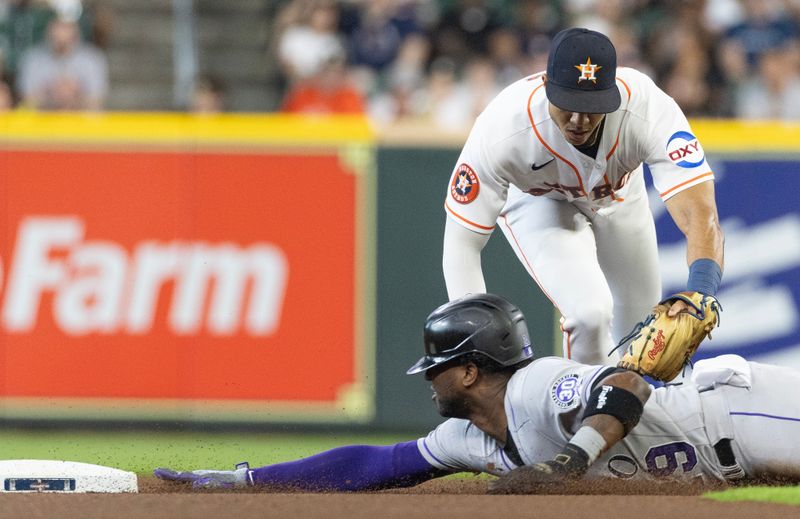 Jul 5, 2023; Houston, Texas, USA; Colorado Rockies left fielder Jurickson Profar (29) reaches for second base as Houston Astros second baseman Mauricio Dubon (14) makes the tag in the first inning at Minute Maid Park. Mandatory Credit: Thomas Shea-USA TODAY Sports