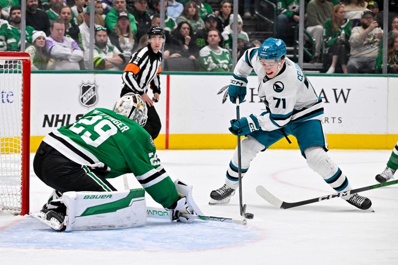 Nov 20, 2024; Dallas, Texas, USA; San Jose Sharks center Macklin Celebrini (71) attempts a shot on net as Dallas Stars goaltender Jake Oettinger (29) defends during the third period at the American Airlines Center. Mandatory Credit: Jerome Miron-Imagn Images