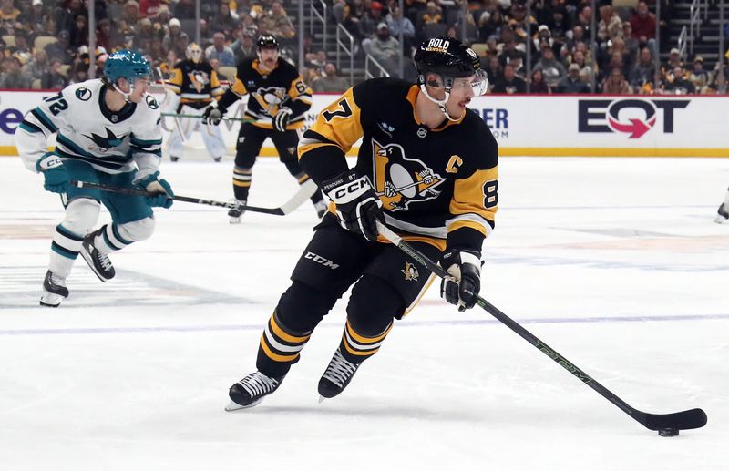 Nov 16, 2024; Pittsburgh, Pennsylvania, USA;  Pittsburgh Penguins center Sidney Crosby (87) moves the puck into the offensive zone against the San Jose Sharks during the third period at PPG Paints Arena. Mandatory Credit: Charles LeClaire-Imagn Images