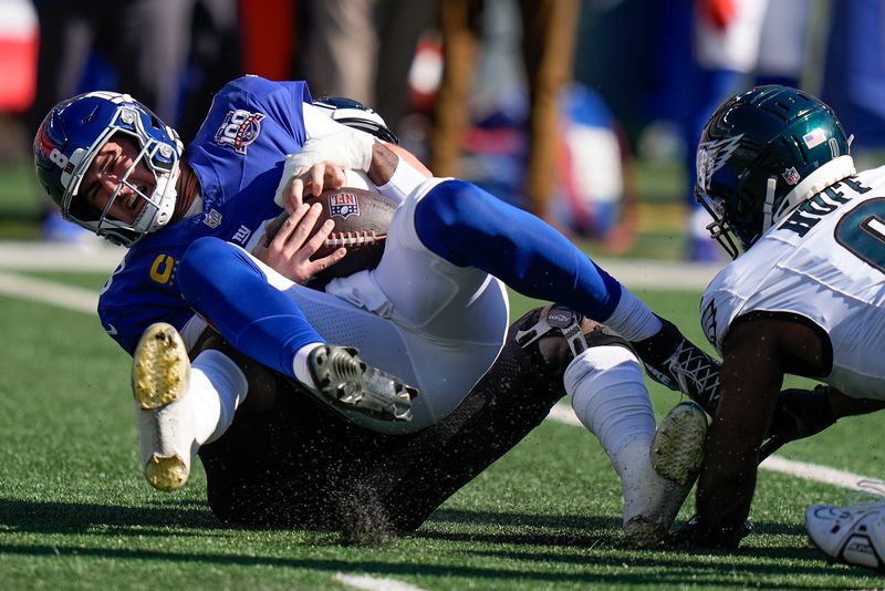 New York Giants quarterback Daniel Jones (8) is sacked by Philadelphia Eagles linebacker Josh Sweat (19) during the first quarter of an NFL football game, Sunday, Oct. 20, 2024, in East Rutherford, N.J. (AP Photo/Frank Franklin II)