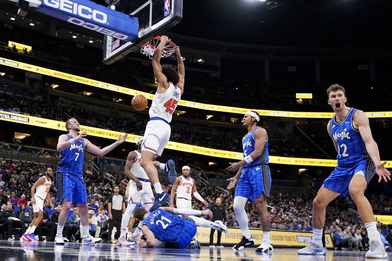 ORLANDO, FLORIDA - FEBRUARY 14: Jericho Sims #45 of the New York Knicks dunks the ball over Moritz Wagner #21 of the Orlando Magic during the second quarter at Kia Center on February 14, 2024 in Orlando, Florida. NOTE TO USER: User expressly acknowledges and agrees that, by downloading and or using this photograph, user is consenting to the terms and conditions of the Getty Images License Agreement. (Photo by Rich Storry/Getty Images)