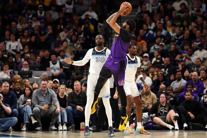 MINNEAPOLIS, MINNESOTA - DECEMBER 02: Anthony Davis #3 of the Los Angeles Lakers shoots the ball against Julius Randle #30 of the Minnesota Timberwolves in the second quarter at Target Center on December 02, 2024 in Minneapolis, Minnesota. NOTE TO USER: User expressly acknowledges and agrees that, by downloading and or using this photograph, User is consenting to the terms and conditions of the Getty Images License Agreement. (Photo by David Berding/Getty Images)