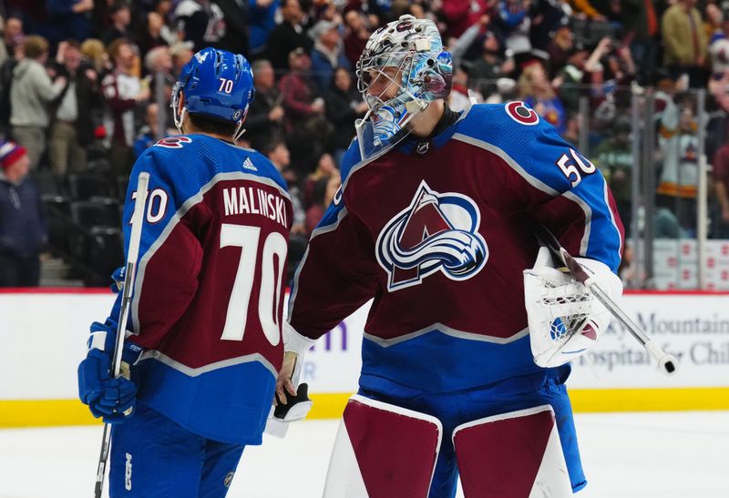 Dec 13, 2023; Denver, Colorado, USA; Colorado Avalanche goaltender Ivan Prosvetov (50) congratulates defenseman Sam Malinski (70) for his goal in the third period against the Buffalo Sabres at Ball Arena. Mandatory Credit: Ron Chenoy-USA TODAY Sports