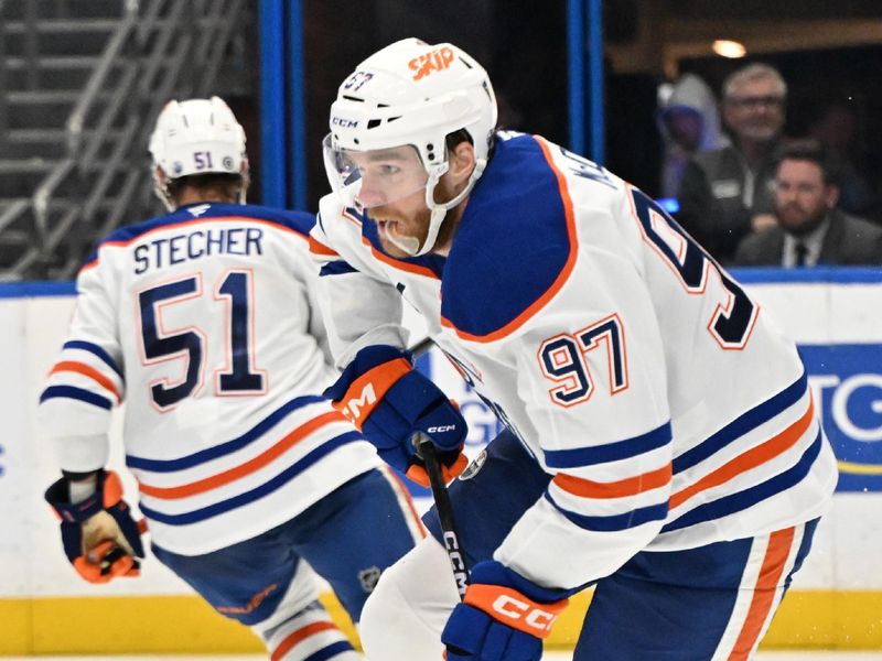 Feb 25, 2025; Tampa, Florida, USA; Edmonton Oilers center Connor McDavid (97) looks for an open teammate in the third period against the Tampa Bay Lightning period  at Amalie Arena. Mandatory Credit: Jonathan Dyer-Imagn Images