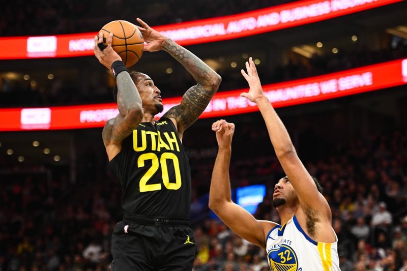 SALT LAKE CITY, UTAH - OCTOBER 25: John Collins #20 of the Utah Jazz shoots over Trayce Jackson-Davis #32 of the Golden State Warriors during the first half of a game at Delta Center on October 25, 2024 in Salt Lake City, Utah. NOTE TO USER: User expressly acknowledges and agrees that, by downloading and or using this photograph, User is consenting to the terms and conditions of the Getty Images License Agreement. (Photo by Alex Goodlett/Getty Images)