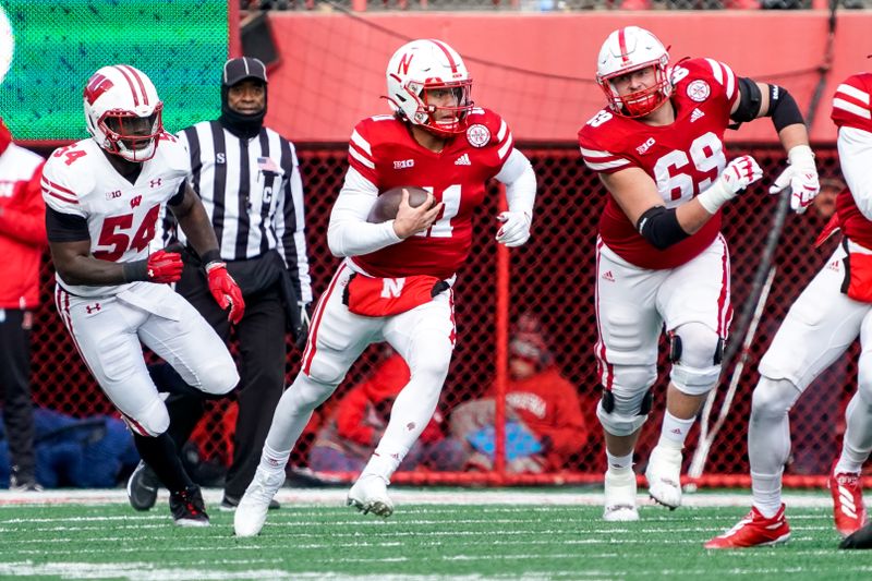 Nov 19, 2022; Lincoln, Nebraska, USA; Nebraska Cornhuskers quarterback Casey Thompson (11) runs with the ball against the Wisconsin Badgers during the third quarter at Memorial Stadium. Mandatory Credit: Dylan Widger-USA TODAY Sports