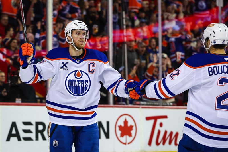 Dec 27, 2025; Calgary, Alberta, CAN; Edmonton Oilers center Connor McDavid (97) celebrates his goal with teammates against the Calgary Flames during the third period at Scotiabank Saddledome. Mandatory Credit: Sergei Belski-Imagn Images