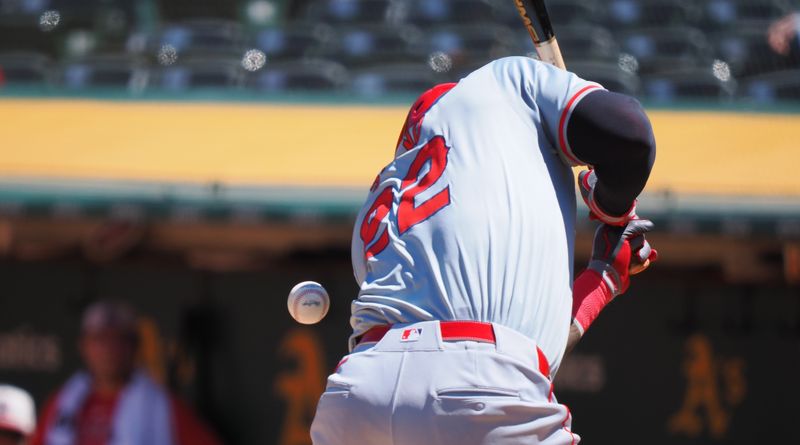 Jul 4, 2024; Oakland, California, USA; Los Angeles Angels third baseman Miguel Sano (22) is hit by pitch during the sixth inning against the Oakland Athletics at Oakland-Alameda County Coliseum. Mandatory Credit: Kelley L Cox-USA TODAY Sports