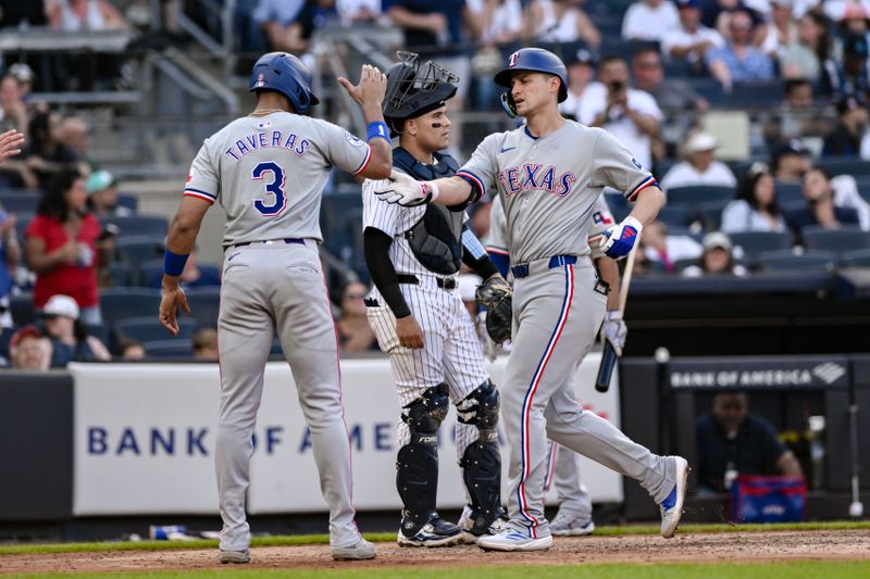 Aug 10, 2024; Bronx, New York, USA; Texas Rangers shortstop Corey Seager (5) is greeted at home plate by Texas Rangers outfielder Leody Taveras (3) after hitting a three run home run against the New York Yankees during the sixth inning at Yankee Stadium. Mandatory Credit: John Jones-USA TODAY Sports