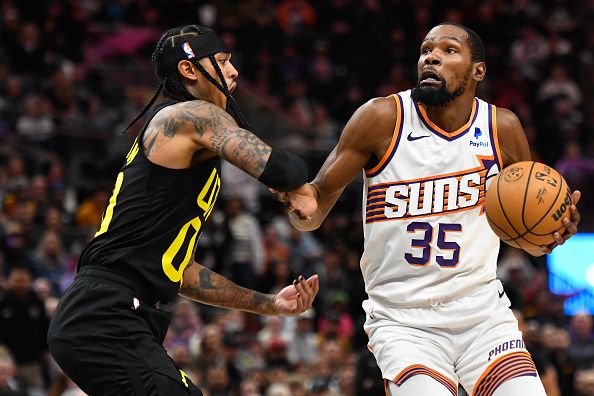 SALT LAKE CITY, UTAH - NOVEMBER 19: Jordan Clarkson #00 of the Utah Jazz defends Kevin Durant #35 of the Phoenix Sunsduring the second half of a game at Delta Center on November 19, 2023 in Salt Lake City, Utah. NOTE TO USER: User expressly acknowledges and agrees that, by downloading and or using this photograph, User is consenting to the terms and conditions of the Getty Images License Agreement. (Photo by Alex Goodlett/Getty Images)