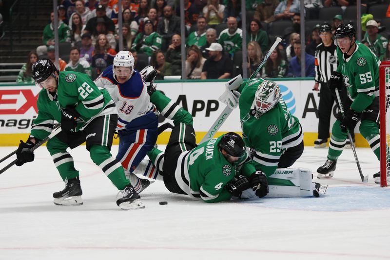 Oct 19, 2024; Dallas, Texas, USA; Edmonton Oilers left wing Zach Hyman (18) battles for the puck against Dallas Stars center Mavrik Bourque (22) and defenseman Miro Heiskanen (4) and goaltender Jake Oettinger (29) in the first period at American Airlines Center. Mandatory Credit: Tim Heitman-Imagn Images