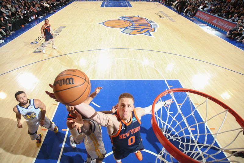 NEW YORK, NY - FEBRUARY 29: Donte Divincenzo #0 of the New York Knicks grabs a rebound during the game against the New York Knicks on January 29, 2024 at Madison Square Garden in New York City, New York.  NOTE TO USER: User expressly acknowledges and agrees that, by downloading and or using this photograph, User is consenting to the terms and conditions of the Getty Images License Agreement. Mandatory Copyright Notice: Copyright 2024 NBAE  (Photo by Nathaniel S. Butler/NBAE via Getty Images)