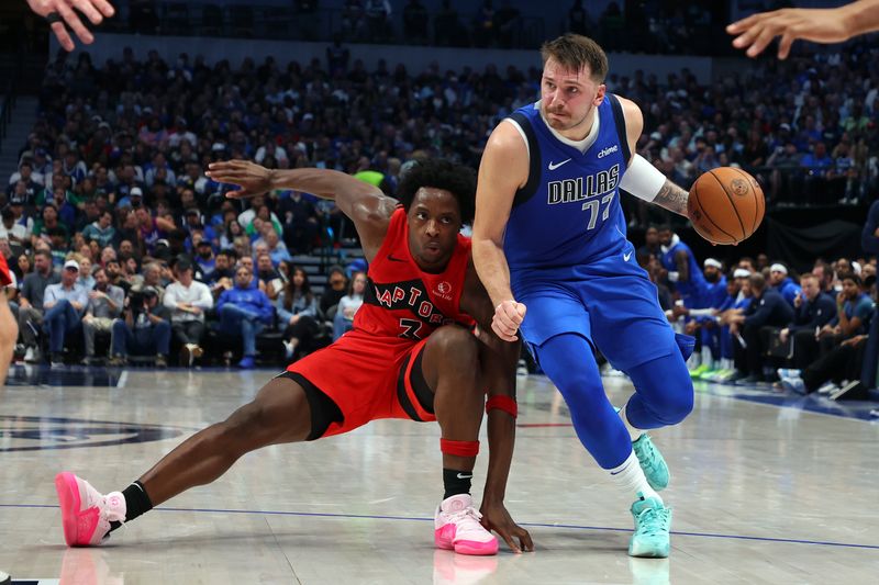 DALLAS, TEXAS - NOVEMBER 08: O.G. Anunoby #3 of the Toronto Raptors stumbles as Luka Doncic #77 of the Dallas Mavericks drives past in the first half at American Airlines Center on November 08, 2023 in Dallas, Texas. NOTE TO USER: User expressly acknowledges and agrees that, by downloading and or using this photograph, User is consenting to the terms and conditions of the Getty Images License Agreement.  (Photo by Richard Rodriguez/Getty Images)