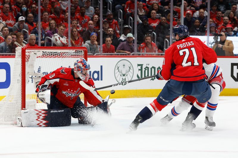 Apr 28, 2024; Washington, District of Columbia, USA; Washington Capitals goaltender Charlie Lindgren (79) makes a save on New York Rangers center Mika Zibanejad (93) as Capitals center Aliaksei Protas (21) defends in the second period in game four of the first round of the 2024 Stanley Cup Playoffs at Capital One Arena. Mandatory Credit: Geoff Burke-USA TODAY Sports