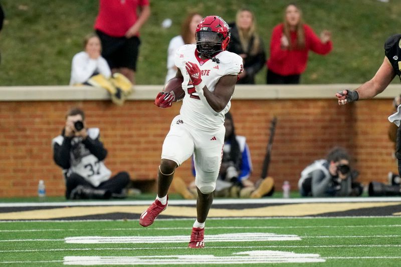 Nov 11, 2023; Winston-Salem, North Carolina, USA; North Carolina State Wolfpack linebacker Jaylon Scott (2) intercepts an extra point attempt by Wake Forest Demon Deacons during the second half at Allegacy Federal Credit Union Stadium. Mandatory Credit: Jim Dedmon-USA TODAY Sports