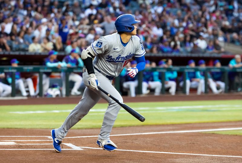 May 9, 2025; Phoenix, Arizona, USA; Los Angeles Dodgers designated hitter Shohei Ohtani hits a double in the first inning against the Arizona Diamondbacks at Chase Field. Mandatory Credit: Mark J. Rebilas-Imagn Images