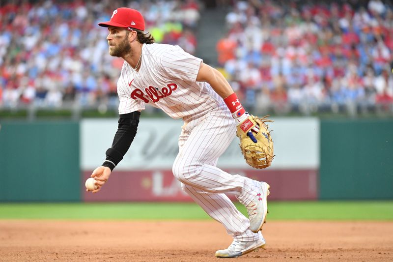 Jul 26, 2023; Philadelphia, Pennsylvania, USA; Philadelphia Phillies first baseman Bryce Harper (3) flips the ball to first base against the Baltimore Orioles at Citizens Bank Park. Mandatory Credit: Eric Hartline-USA TODAY Sports