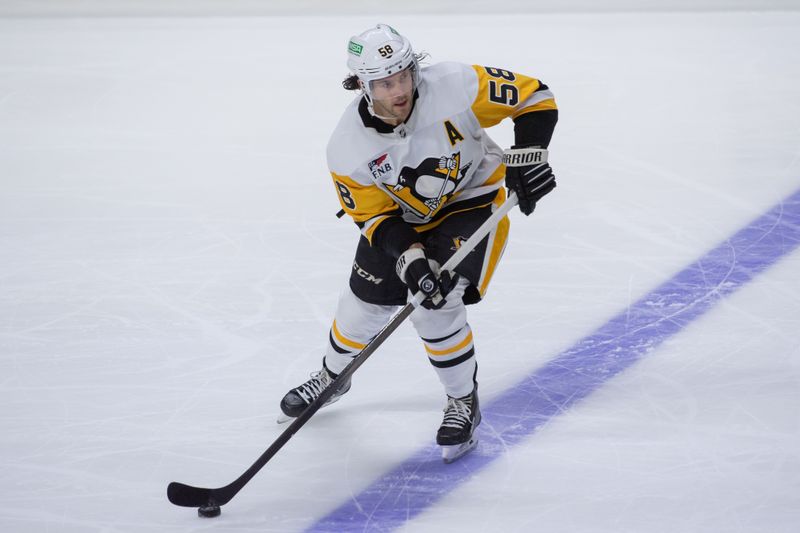 Dec 23, 2023; Ottawa, Ontario, CAN; Pittsburgh Penguins defenseman Kris Letang (58) skates with the puck in the third period against the  Ottawa Senators at the Canadian Tire Centre. Mandatory Credit: Marc DesRosiers-USA TODAY Sports