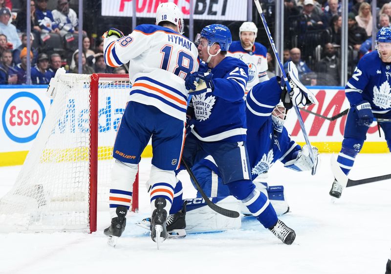 Dec 13, 2025; Toronto, Ontario, CAN; Edmonton Oilers left wing Zach Hyman (18) battles either Toronto Maple Leafs defenseman Troy Stecher (28) in front of the net during the second period at Scotiabank Arena. Mandatory Credit: Nick Turchiaro-Imagn Images