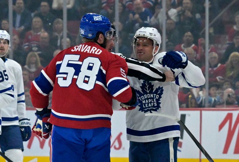 Oct 9, 2024; Montreal, Quebec, CAN; Toronto Maple Leafs forward Max Domi (11) punches Montreal Canadiens defenseman David Savard (58) during the first period at the Bell Centre. Mandatory Credit: Eric Bolte-Imagn Images