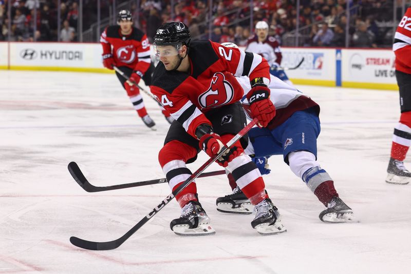 Feb 6, 2024; Newark, New Jersey, USA; New Jersey Devils defenseman Colin Miller (24) skates with the puck against the Colorado Avalanche during the first period at Prudential Center. Mandatory Credit: Ed Mulholland-USA TODAY Sports