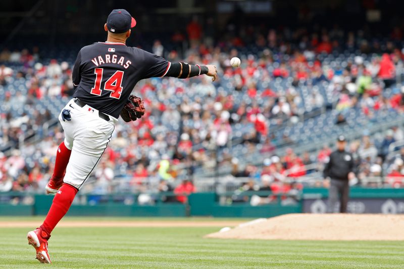 Apr 21, 2024; Washington, District of Columbia, USA; Washington Nationals second base Ildemaro Vargas (14) makes a throw to first base on a ground ball by Houston Astros third base Alex Bregman (not pictured) during the seventh inning at Nationals Park. Mandatory Credit: Geoff Burke-USA TODAY Sports