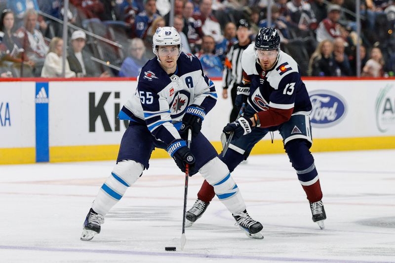 Apr 13, 2024; Denver, Colorado, USA; Winnipeg Jets center Mark Scheifele (55) controls the puck ahead of Colorado Avalanche right wing Valeri Nichushkin (13) in the third period at Ball Arena. Mandatory Credit: Isaiah J. Downing-USA TODAY Sports