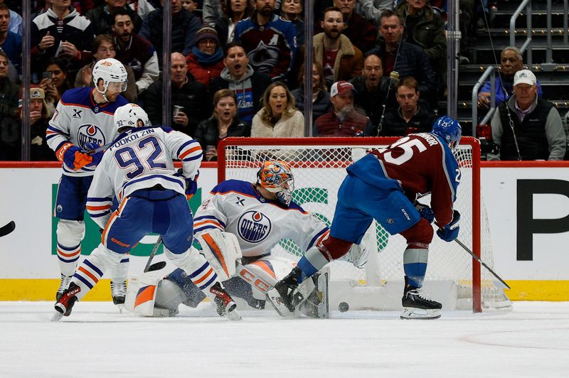 Jan 16, 2025; Denver, Colorado, USA; Colorado Avalanche right wing Logan O'Connor (25) scores a goal against Edmonton Oilers goaltender Stuart Skinner (74) as right wing Vasily Podkolzin (92) and defenseman Brett Kulak (27) defend in the first period at Ball Arena. Mandatory Credit: Isaiah J. Downing-Imagn Images