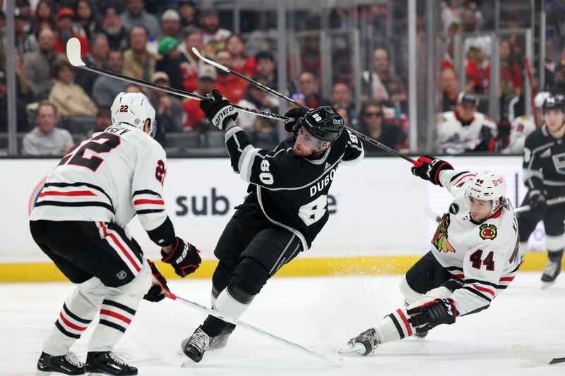 Mar 19, 2024; Los Angeles, California, USA;  Los Angeles Kings center Pierre-Luc Dubois (80) takes a slapshot against Chicago Blackhawks defenseman Nikita Zaitsev (22) during the first period at Crypto.com Arena. Mandatory Credit: Kiyoshi Mio-USA TODAY Sports