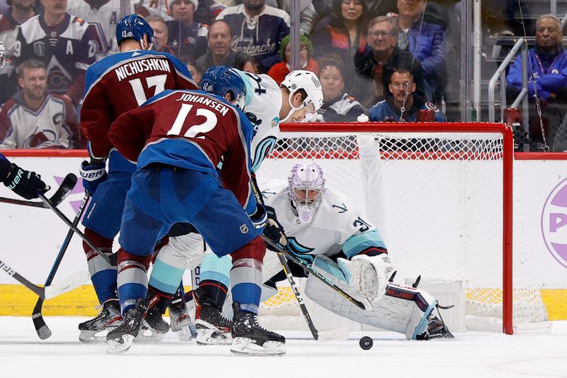 Nov 9, 2023; Denver, Colorado, USA; Seattle Kraken defenseman Jamie Oleksiak (24) battles for the puck with Colorado Avalanche center Ryan Johansen (12) and right wing Valeri Nichushkin (13) as goaltender Philipp Grubauer (31) defends in the third period at Ball Arena. Mandatory Credit: Isaiah J. Downing-USA TODAY Sports