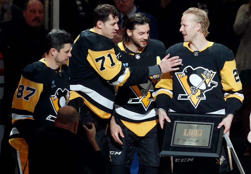 Jan 27, 2024; Pittsburgh, Pennsylvania, USA;  Pittsburgh Penguins teammates center Sidney Crosby (87) and center Evgeni Malkin (71) and defenseman Kris Letang (58) congratulate center Lars Eller (20) prior to Eller playing in his 1000th career NHL game. As a native of Rodovre Denmark, Eller becomes the first Danish born player to reach the milestone. The Penguins host the Montreal Canadiens at PPG Paints Arena. Mandatory Credit: Charles LeClaire-USA TODAY Sports