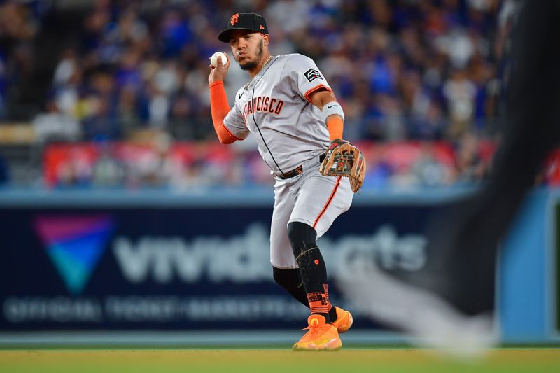 Apr 3, 2024; Los Angeles, California, USA; San Francisco Giants second baseman Thairo Estrada (39) throws to first for the out against Los Angeles Dodgers left fielder Chris Taylor (3) during the fourth inning at Dodger Stadium. Mandatory Credit: Gary A. Vasquez-USA TODAY Sports