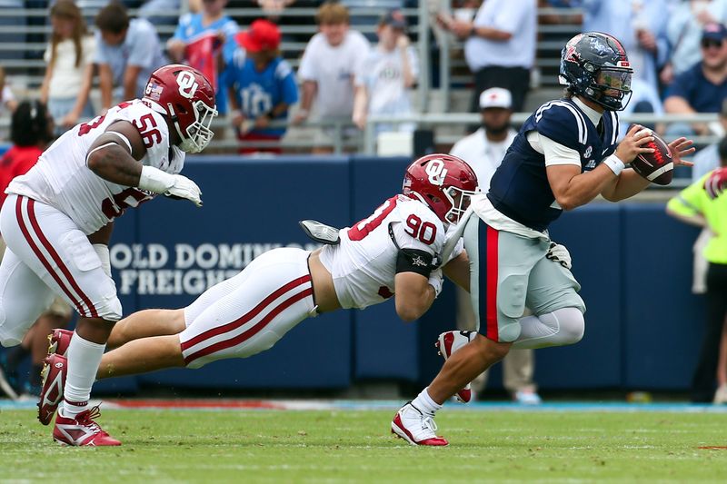 Oct 26, 2024; Oxford, Mississippi, USA; Mississippi Rebels quarterback Jaxson Dart (2) scrambles as Oklahoma Sooners defensive lineman Caiden Woullard (90) makes the tackle during the second half at Vaught-Hemingway Stadium. Mandatory Credit: Petre Thomas-Imagn Images