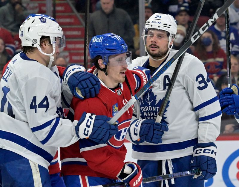 Mar 9, 2024; Montreal, Quebec, CAN; Toronto Maple Leafs defenseman Morgan Rielly (44) and teammate Toronto Maple Leafs forward Auston Matthews (34) escort Montreal Canadiens forward Brendan Gallagher (11) away from their net during the second period at the Bell Centre. Mandatory Credit: Eric Bolte-USA TODAY Sports